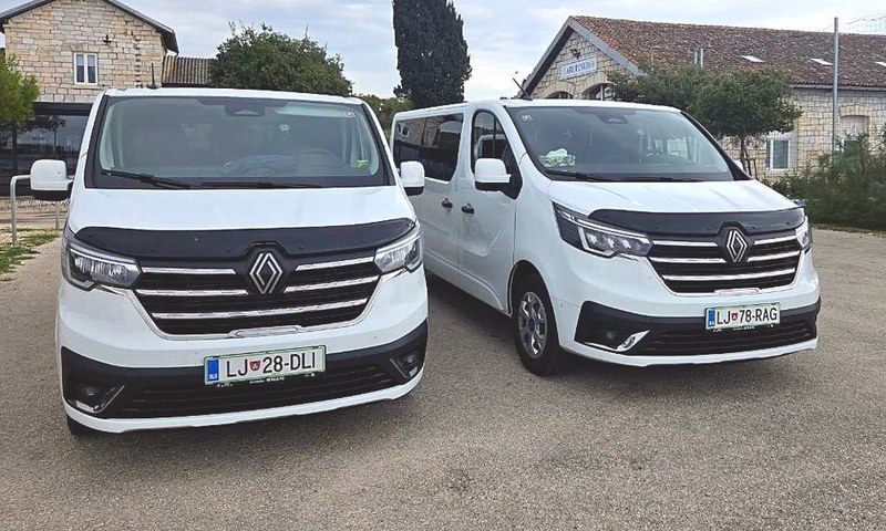Two white TourSlo Renault Trafic vans from the front
