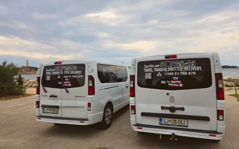 Two white TourSlo Renault Trafic vans from behind, by the sea in Rovinj